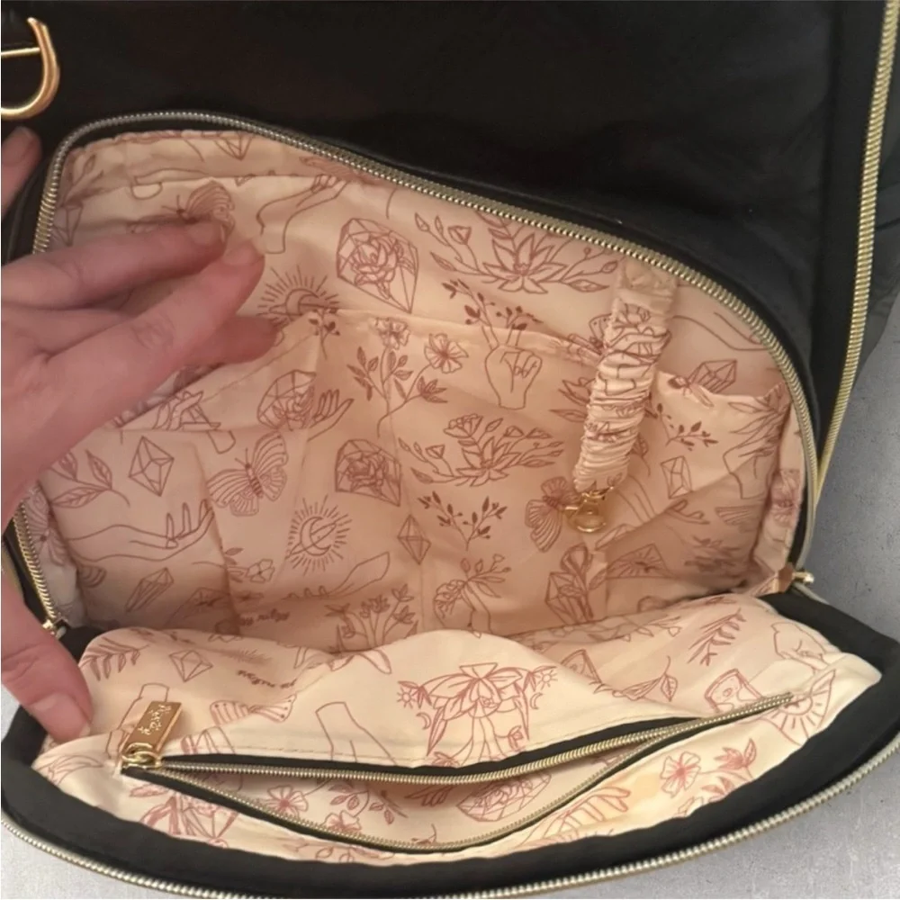Itzy Ritzy Boss Plus black diaper bag backpack with gold hardware.